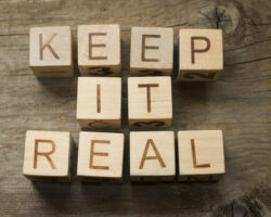 Keep,it,real,text,on,a,wooden,background