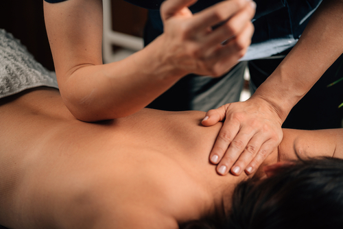 Deep,tissue,massage,therapy.,therapist,massaging,womans,back,,using,elbow